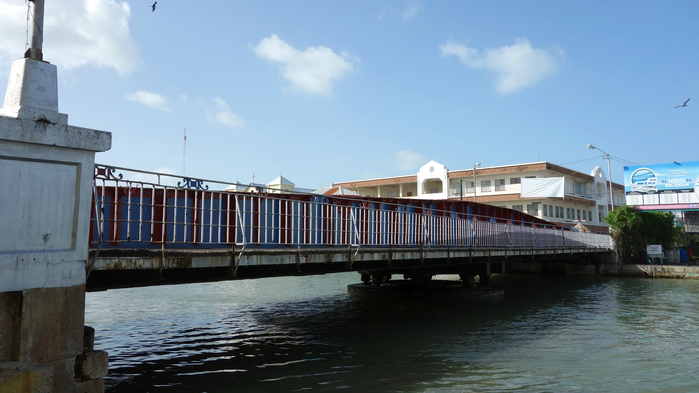Bridge across a channel and buildings in Belize City.