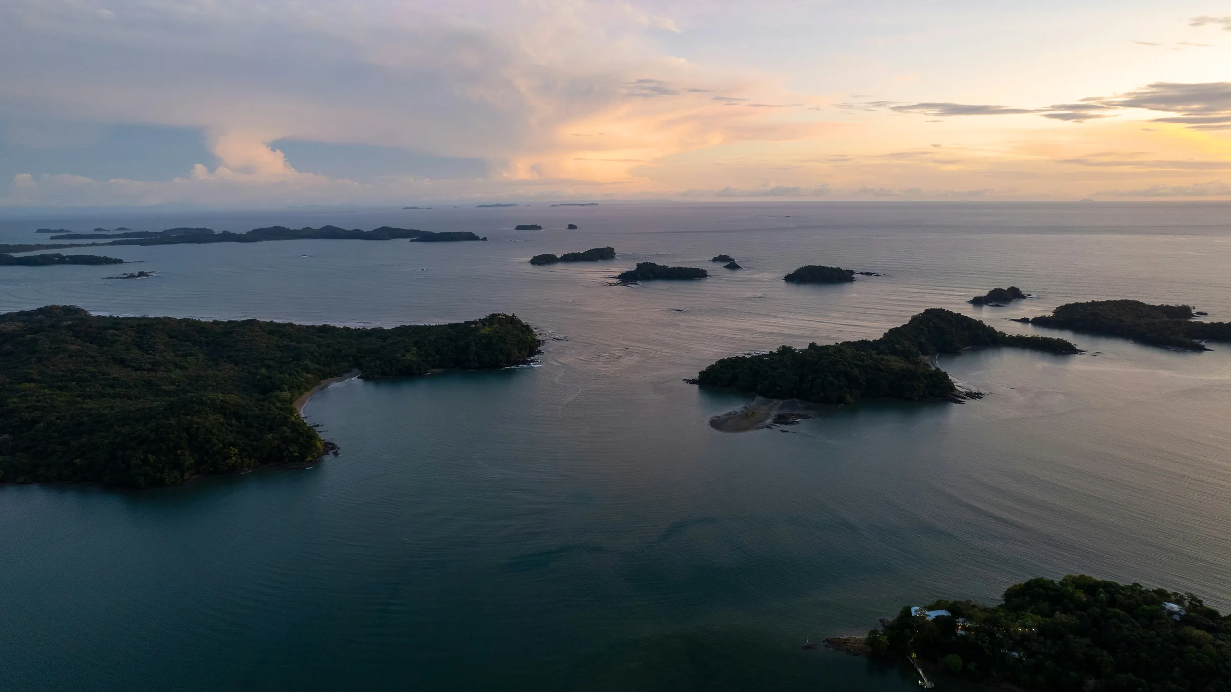 Elevated view of wooded islands in the Gulf of Chiriquí in warm light.