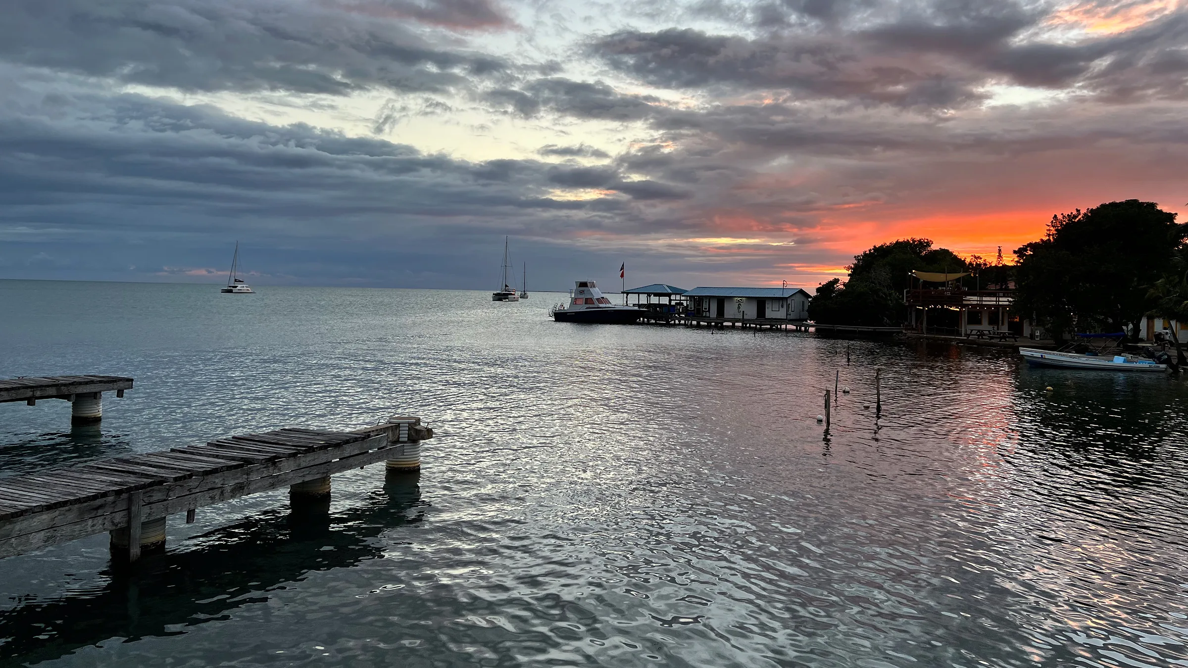 Piers and boats on calm water beneath a sunset sky.