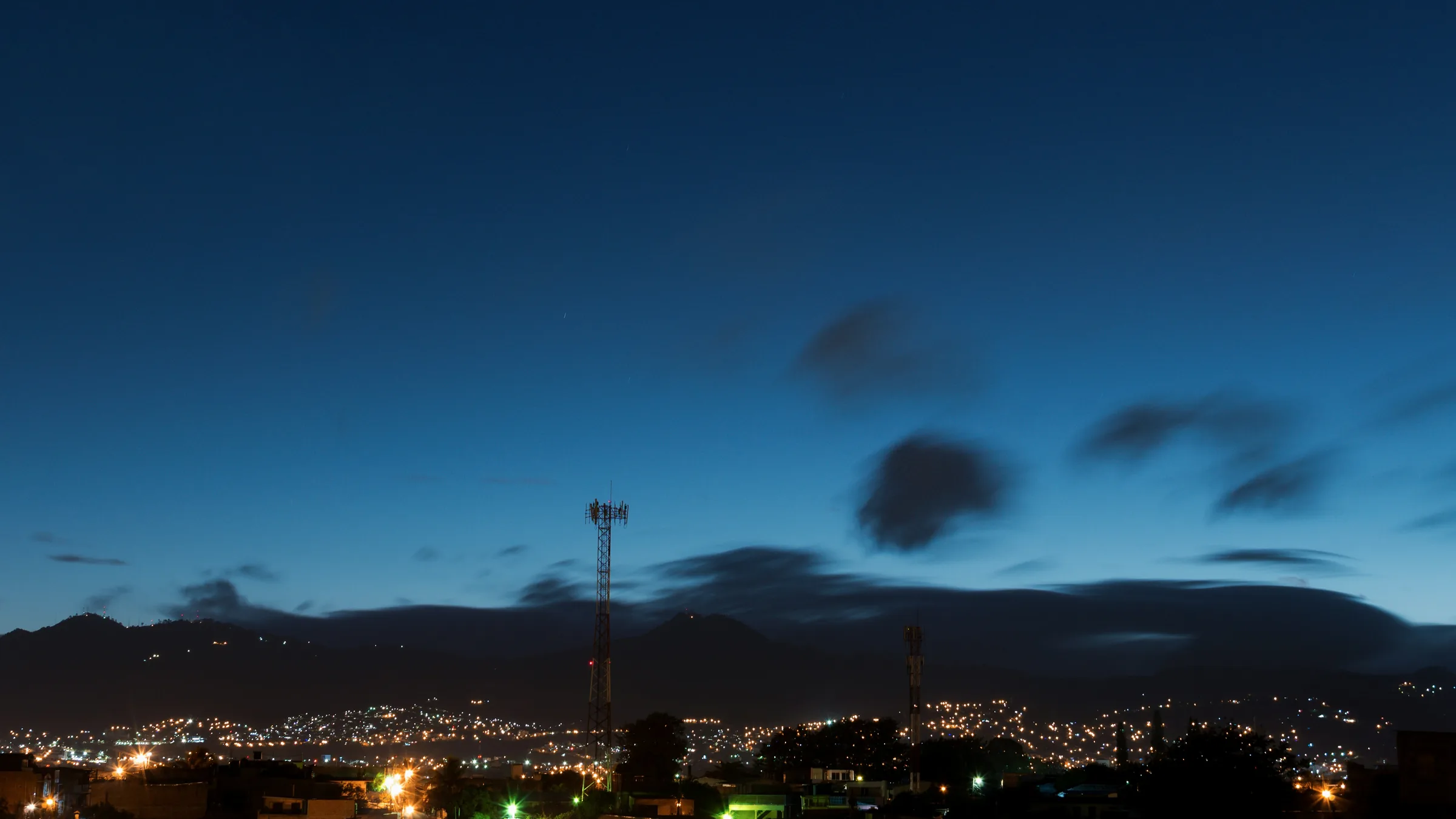 City lights beneath a dark blue sky over Tegucigalpa.