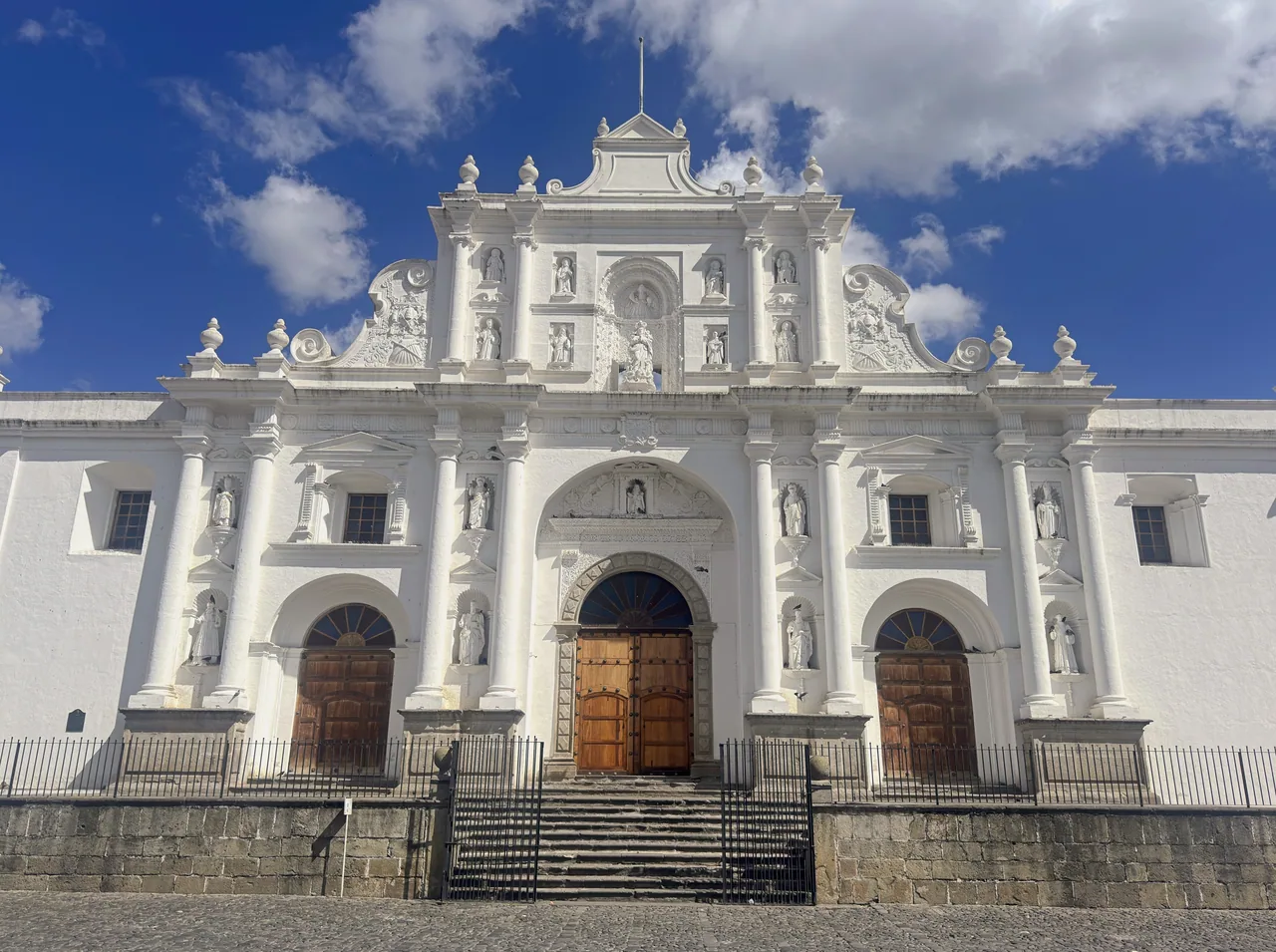 White facade of San José Cathedral beneath a blue sky.