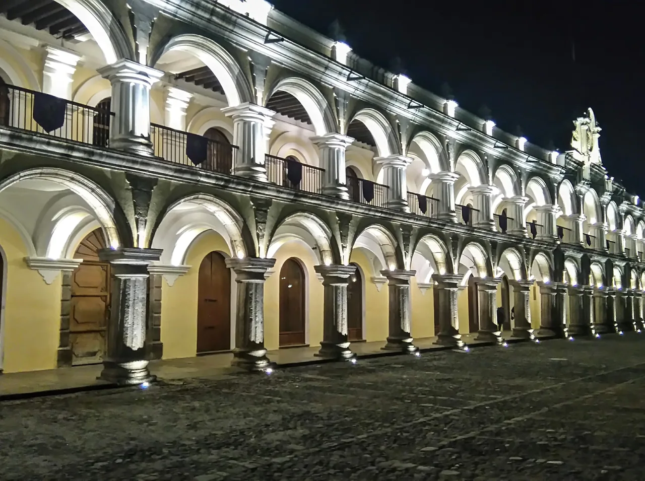 Arcades of the Palace of the Captains General lit at night.
