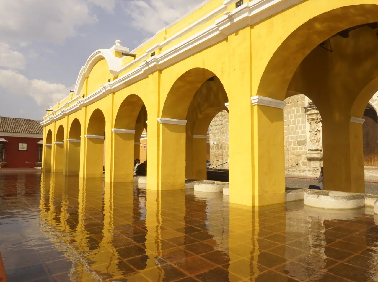 Yellow arches reflected in the water at Tanque La Unión.