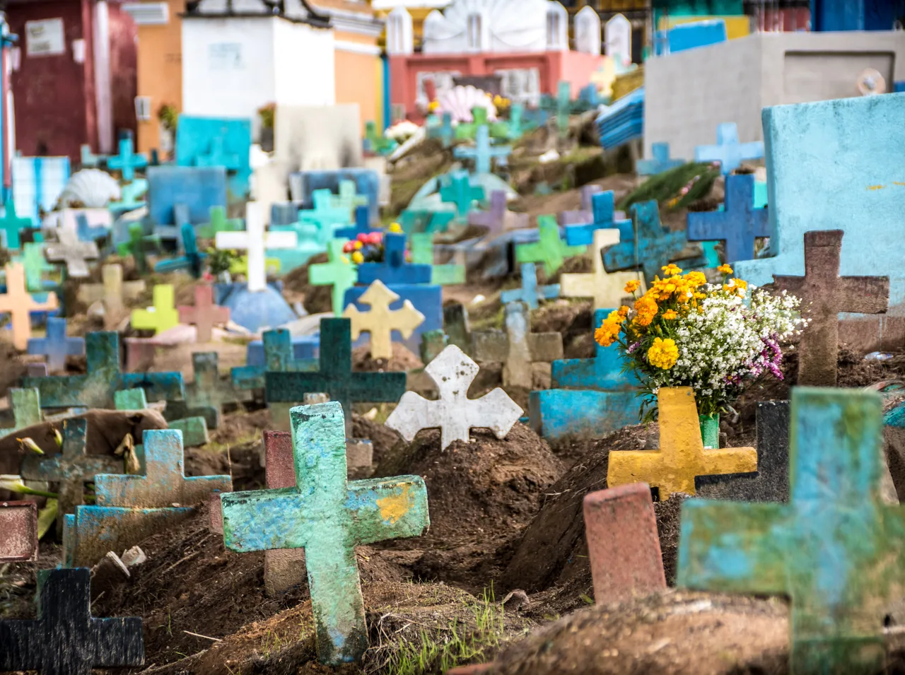 Colourful crosses and graves with flowers in Chichicastenango cemetery.