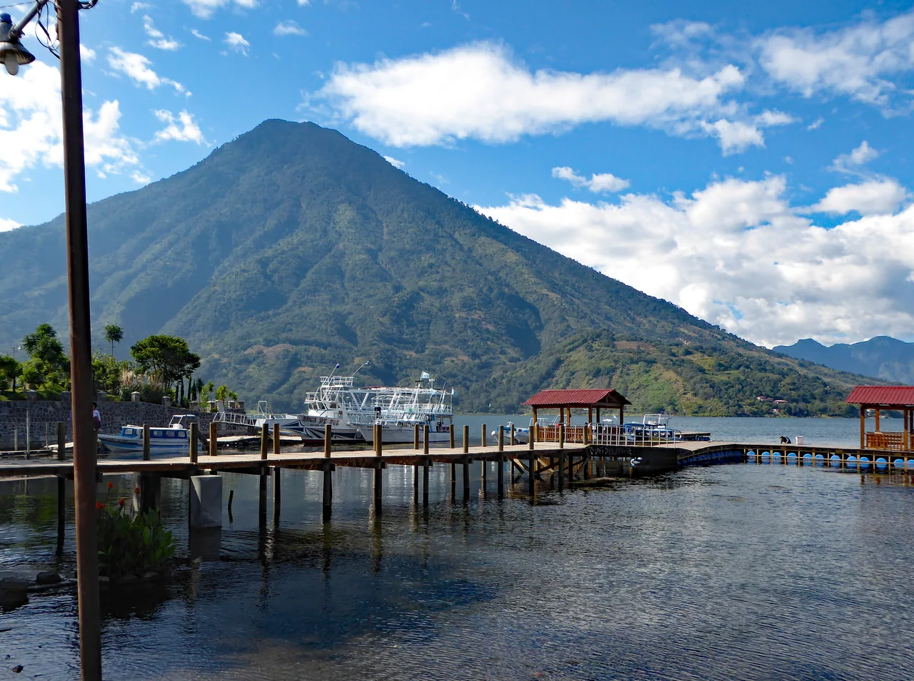 Walkways, boats and docks in Santiago Atitlán, with San Pedro volcano behind.