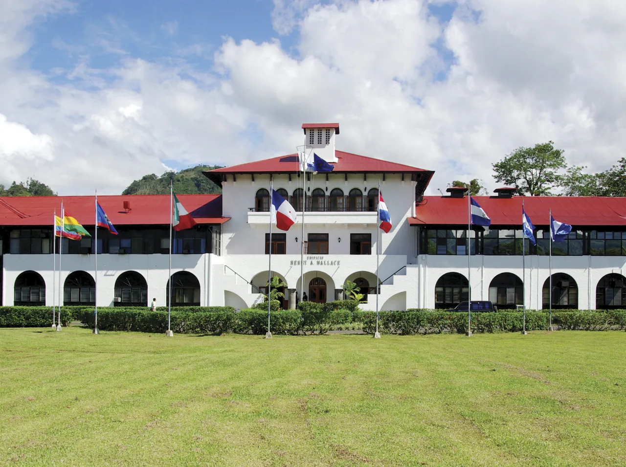 CATIE main building with flags and gardens in Turrialba.
