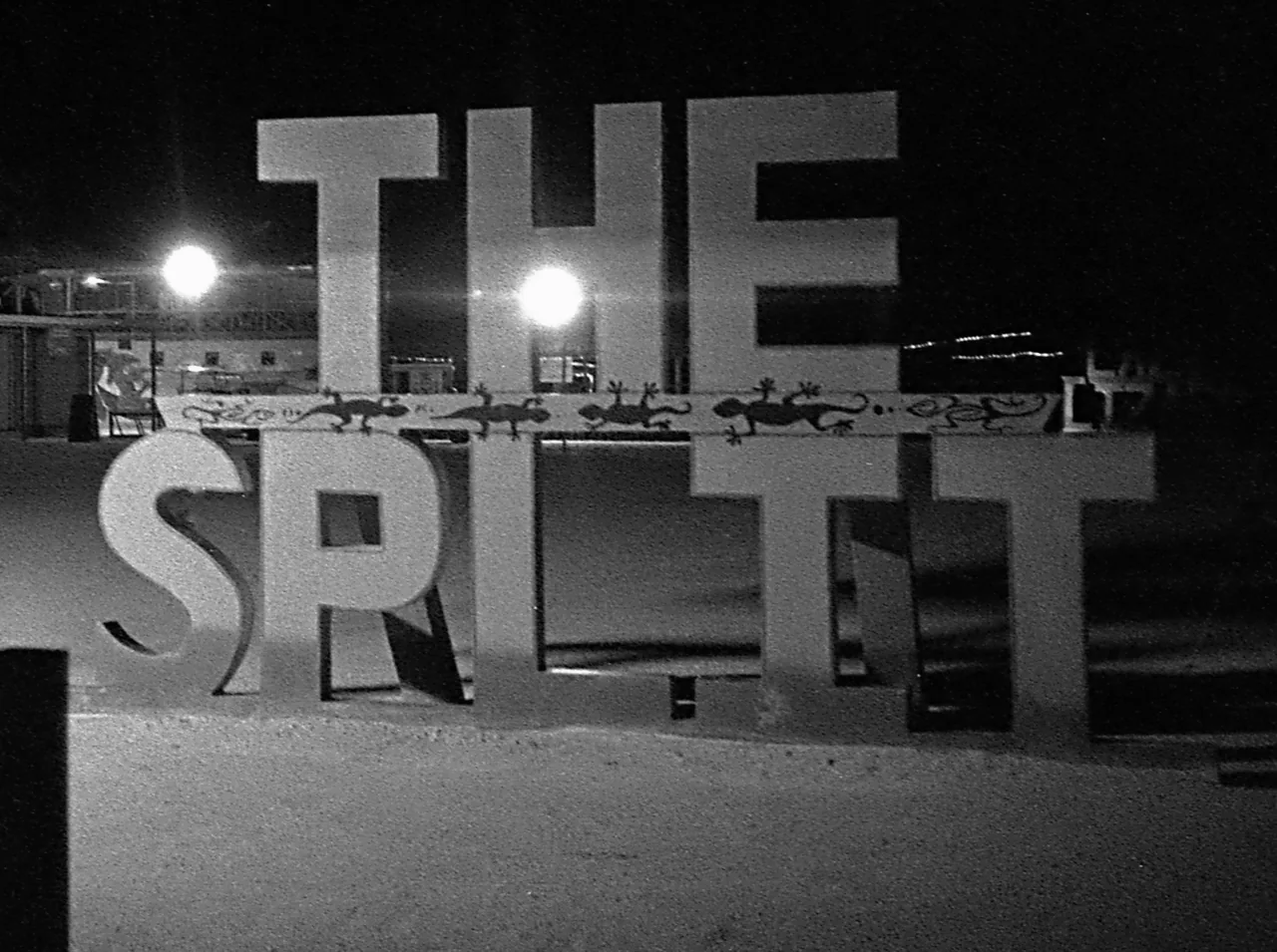 The Split sign at night, in black and white.