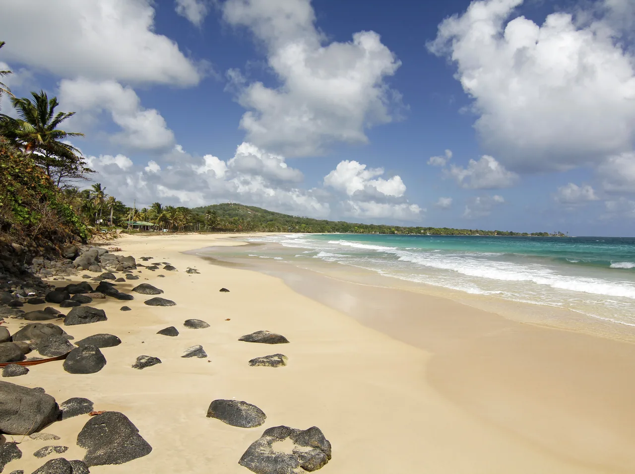 Pale sand, dark rocks and turquoise sea at Long Bay Beach, Big Corn Island.