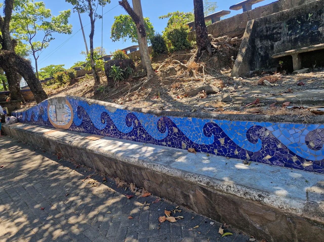 Bench with blue wave mosaics on the Quepos waterfront.