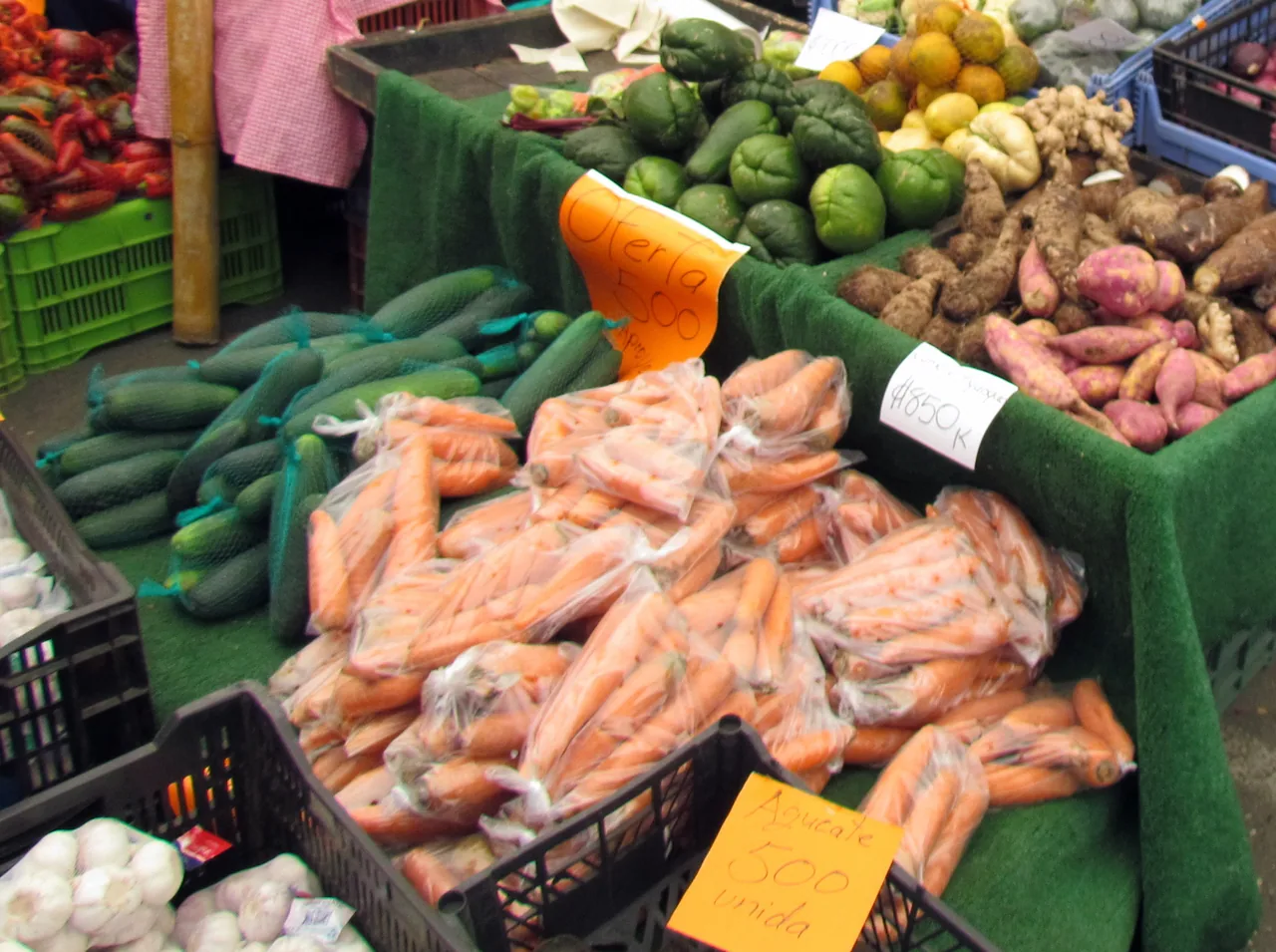 A vegetable stall with carrots, cucumbers, chayotes and root vegetables at the Quepos market.