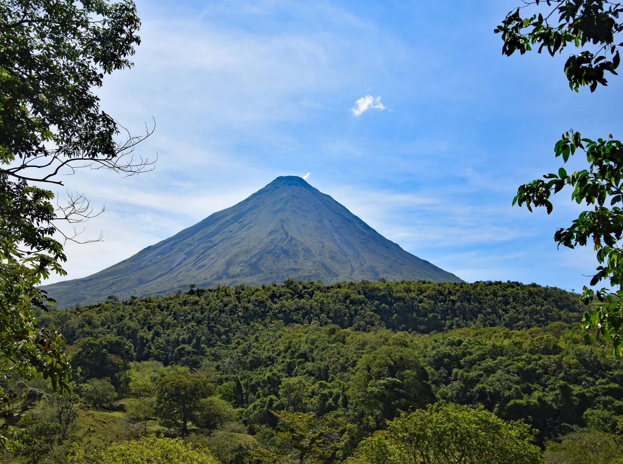 Arenal Volcano framed by trees from Mirador El Silencio.
