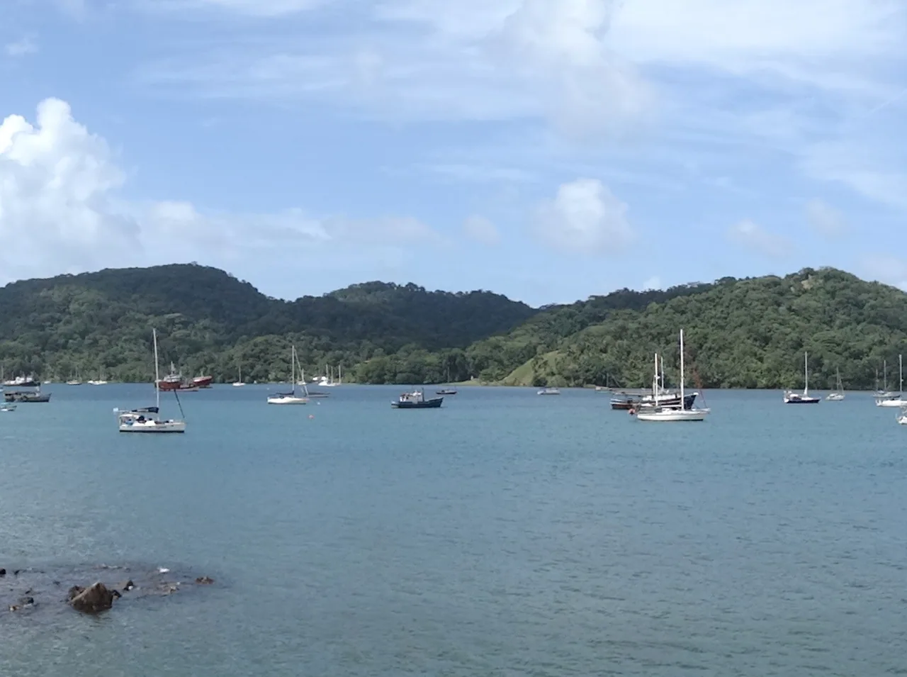 Portobelo Bay with sailboats and coastal hills.
